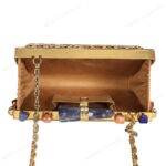 Rare lapis lazuli gemstone handbag with side-adorned gold frame and quartz crystal knob