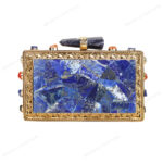 Rare lapis lazuli gemstone handbag with side-adorned gold frame and quartz crystal knob