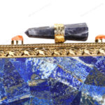 Rare lapis lazuli gemstone handbag with side-adorned gold frame and quartz crystal knob