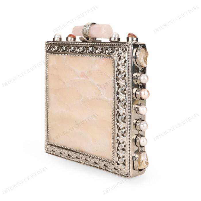 Angle view of White Mother-of-Pearl Purse with Gemstone-Adorned Square Silver Frame and Floral Border