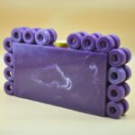 Stylish Resin Purple Ring Clutch with Marble-Like Finish, Adorned with 24 Exquisite Rings