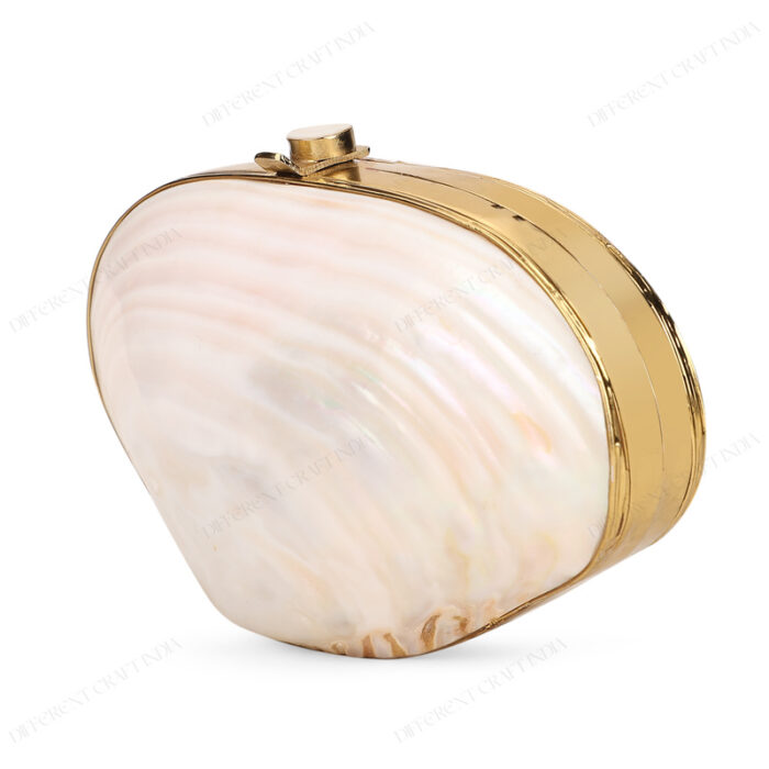 Angled view of a pearl clam shell handbag with a gold-tone frame and iridescent finish.