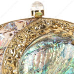 Closeup view of Gold Floral Emabellished Iridescent Clutch Shell with clear crystal knob