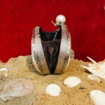 Side view of Iridescent Clam Seashell Clutch Purse with Silver-Tone Metallic Frame with pebbled texture and gemstone knob