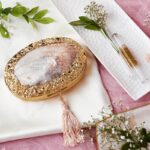 Central Pearlescent Clam Shell Clutch Bag with Gold Embellished Frame and Delicate Tassel