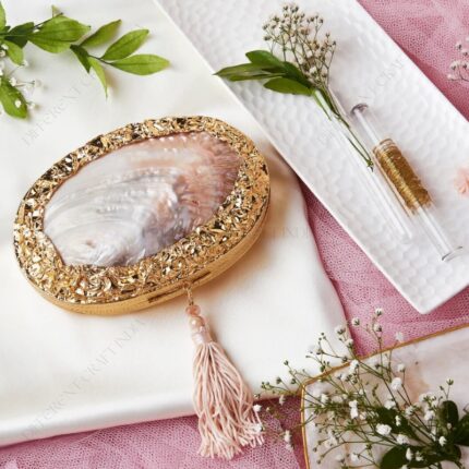 Central Pearlescent Clam Shell Clutch Bag with Gold Embellished Frame and Delicate Tassel