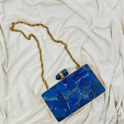 Front view of Lapis lazuli gemstone evening bag with quartz crystal knob and gold brass frame