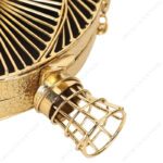 Closeup of Transparent 3D Spiral Gold Metal Clutch showcasing the Unique Cage Closure