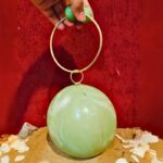 Round Light Green Resin Ball Clutch with Gold-Tone Circular Metal Handle for a Statement Look