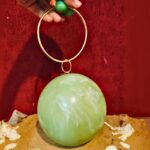 Round Light Green Resin Ball Clutch with Gold-Tone Circular Metal Handle for a Statement Look