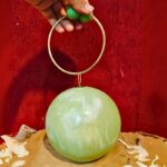 Round Light Green Resin Ball Clutch with Gold-Tone Circular Metal Handle for a Statement Look