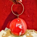 Round Red Resin Ball Clutch with Gold-Tone Circular Metal Handle for a Statement Look