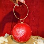 Round Red Resin Ball Clutch with Gold-Tone Circular Metal Handle for a Statement Look